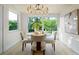 Light-filled dining room with modern chandelier and slider view of the backyard at 243 45Th Ne Ave, St Petersburg, FL 33703