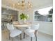 Dining room with modern chandelier, hardwood floors, and an open-concept layout at 243 45Th Ne Ave, St Petersburg, FL 33703