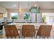 Bright kitchen features a waterfall island with seating, stainless appliances, and modern cabinetry at 243 45Th Ne Ave, St Petersburg, FL 33703