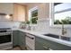 Bright kitchen features stainless appliances, modern cabinetry, a farmhouse sink, and backyard views at 243 45Th Ne Ave, St Petersburg, FL 33703