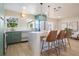 Bright kitchen features a waterfall island with seating, stainless appliances, and modern green cabinetry at 243 45Th Ne Ave, St Petersburg, FL 33703