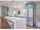 Bright kitchen features a waterfall island with seating, stainless appliances, and modern cabinetry at 243 45Th Ne Ave, St Petersburg, FL 33703
