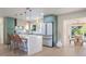 Bright kitchen features a waterfall island with seating, stainless appliances, and modern green cabinetry at 243 45Th Ne Ave, St Petersburg, FL 33703
