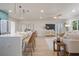 Open-concept living room features a kitchen island with seating, a ceiling fan, and a comfortable seating area at 243 45Th Ne Ave, St Petersburg, FL 33703