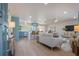 Open-concept living area with wood floors, updated kitchen, and comfortable seating arrangement at 243 45Th Ne Ave, St Petersburg, FL 33703