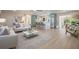 Spacious living room showcases open layout, natural light, and seamless flow to dining and kitchen at 243 45Th Ne Ave, St Petersburg, FL 33703
