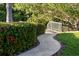 Charming walkway lined with lush greenery and vibrant flowers, leading to a picturesque outdoor setting at 243 45Th Ne Ave, St Petersburg, FL 33703