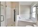Bright bathroom featuring a walk-in shower and a separate soaking tub at 25327 Seven Rivers Cir, Land O Lakes, FL 34639