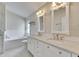 Modern bathroom features marble countertops, dual sinks, and large vanity mirrors at 25327 Seven Rivers Cir, Land O Lakes, FL 34639