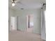 Large bedroom features two doorways, carpet, ceiling fan and bright windows at 25327 Seven Rivers Cir, Land O Lakes, FL 34639