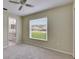 Carpeted bedroom with natural light featuring a ceiling fan and blinds at 25327 Seven Rivers Cir, Land O Lakes, FL 34639