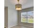 Bright dining room with ample windows and modern chandelier at 25327 Seven Rivers Cir, Land O Lakes, FL 34639