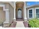 Inviting front entrance with decorative pillars and a charming glass front door at 25327 Seven Rivers Cir, Land O Lakes, FL 34639