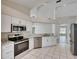 Bright kitchen with stainless steel appliances and granite countertops overlooking the living area at 25327 Seven Rivers Cir, Land O Lakes, FL 34639