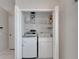 Convenient laundry closet features washer, dryer, and shelving units for storage at 25327 Seven Rivers Cir, Land O Lakes, FL 34639
