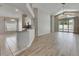 Open-concept living area with hardwood floors, and sliding glass doors that lead to a pool area at 25327 Seven Rivers Cir, Land O Lakes, FL 34639