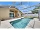 Enclosed backyard pool, view from rear of house, clear skies above at 25327 Seven Rivers Cir, Land O Lakes, FL 34639