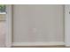 Neutral-toned wall with a grounded outlet and simple baseboards at 25327 Seven Rivers Cir, Land O Lakes, FL 34639