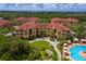 Aerial view of a community with resort-style pool, lush greenery, and well-maintained buildings at 2724 Via Murano # 639, Clearwater, FL 33764