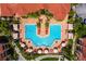 Aerial view highlighting a resort-style pool with lounge chairs and lush landscaping, surrounded by elegant buildings at 2724 Via Murano # 639, Clearwater, FL 33764