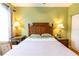 Bedroom featuring wooden furniture, bedside lamps, and a green color scheme at 2724 Via Murano # 639, Clearwater, FL 33764