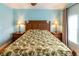 Bedroom features a wooden bed frame, side tables with lamps, and abundant natural light at 2724 Via Murano # 639, Clearwater, FL 33764