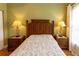 Bedroom featuring a wooden bed frame, two side tables with lamps and a tropical fan above at 2724 Via Murano # 639, Clearwater, FL 33764