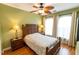 Green bedroom features a decorative bed, tropical ceiling fan, and natural light from the windows at 2724 Via Murano # 639, Clearwater, FL 33764