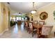 Open-concept dining room with a view into the living room, featuring tile flooring and chandelier lighting at 2724 Via Murano # 639, Clearwater, FL 33764
