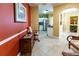 Hallway view into the kitchen, featuring tiled flooring, an accent wall, and wood furnishings at 2724 Via Murano # 639, Clearwater, FL 33764