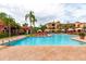 Resort-style community pool surrounded by lounge chairs, palm trees, and meticulously landscaped grounds at 2724 Via Murano # 639, Clearwater, FL 33764