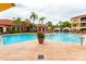 Resort-style pool area with palm trees, lounge chairs, cabanas, and a clubhouse for upscale community living at 2724 Via Murano # 639, Clearwater, FL 33764
