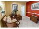 Sitting area featuring decor, tiled floor, and a stylish wicker chair with colorful patterned cushions at 2724 Via Murano # 639, Clearwater, FL 33764