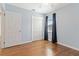 Bedroom featuring hardwood floors, blue walls, closet, window with blinds, and a ceiling fan at 2834 10Th N Ave, St Petersburg, FL 33713