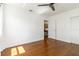 Open bedroom with hardwood floors, and an open doorway to another room at 2834 10Th N Ave, St Petersburg, FL 33713
