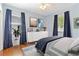 Relaxing bedroom with hardwood floors, ceiling fan, and white dresser beneath beach themed photographs at 2834 10Th N Ave, St Petersburg, FL 33713