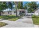 Street view showing a well maintained home with a long driveway, landscaping, and mature trees at 2834 10Th N Ave, St Petersburg, FL 33713