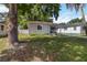 Charming home exterior with beautiful landscaping, a bench on the porch, and lush green lawn at 2834 10Th N Ave, St Petersburg, FL 33713