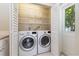 Laundry room with washer and dryer, wire shelving, and a bright white door at 2834 10Th N Ave, St Petersburg, FL 33713