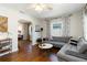 Open concept living room showcasing hardwood floors and a gray sofa at 2834 10Th N Ave, St Petersburg, FL 33713