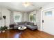 Bright living room with hardwood floors, ceiling fan, and a comfortable gray sectional sofa at 2834 10Th N Ave, St Petersburg, FL 33713