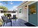 Outdoor patio featuring table and chairs, a green door, and exterior light fixture at 2834 10Th N Ave, St Petersburg, FL 33713