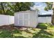 Backyard storage shed featuring double doors, a small window, and full privacy fence at 2834 10Th N Ave, St Petersburg, FL 33713