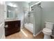 Well-lit bathroom features a modern vanity, granite countertop, and a shower-tub combination with tiled walls at 2950 N North Oriente Avenue N Ave, Sarasota, FL 34235