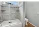 Updated bathroom with tiled shower and tub featuring glass partition and a modern toilet at 2950 N North Oriente Avenue N Ave, Sarasota, FL 34235