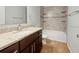 Modern bathroom with granite countertop vanity and tiled shower-tub combination at 2950 N North Oriente Avenue N Ave, Sarasota, FL 34235