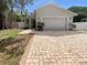 Charming single-story home with a brick driveway and a well-maintained front yard at 2950 N North Oriente Avenue N Ave, Sarasota, FL 34235