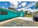 Backyard featuring a fenced-in yard, concrete patio, and teal exterior at 3119 Roberta St, Largo, FL 33771