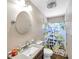 Cozy bathroom featuring a shower with a whimsical lemon-themed curtain and vanity with granite countertop at 3119 Roberta St, Largo, FL 33771