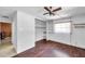 Bedroom featuring hardwood floors, ceiling fan, closet and built-in shelves at 3119 Roberta St, Largo, FL 33771